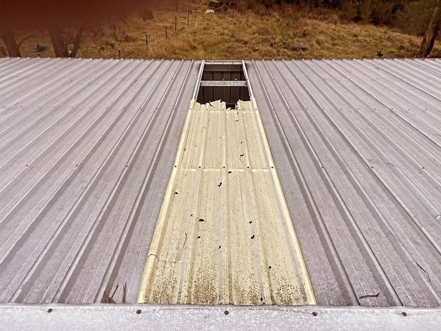 Damaged skylight panel on a corrugated metal roof