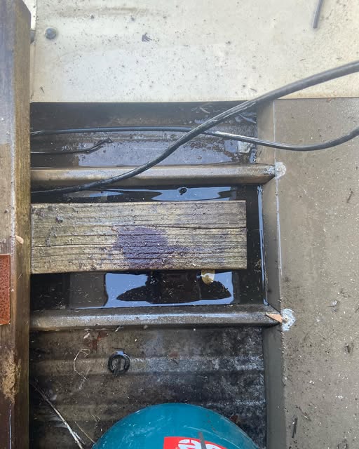 Box gutter with standing water during a roof repair