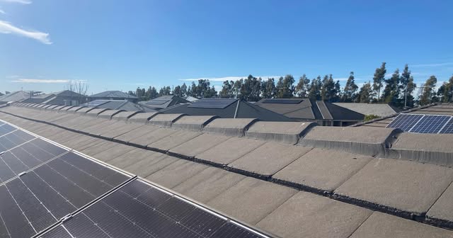 Tiled roof with solar panels during a roofing job